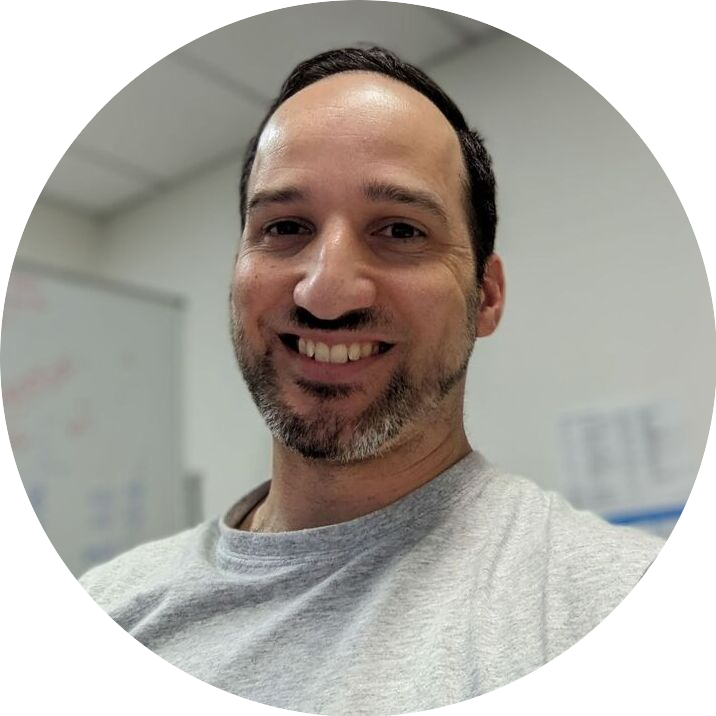 Portrait of Darren, a team member at OptimySME, smiling in a professional setting.